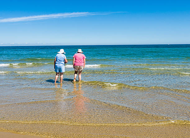 pescatore in acqua - women wading sun hat summer foto e immagini stock