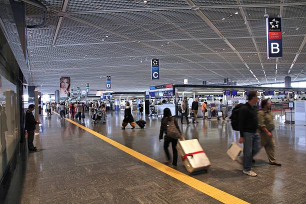 Tokyo Narita Airport Tokyo, Japan - May 12, 2012: Travelers hurry on May 12, 2012 at Narita International Airport, Tokyo. Narita was the 2nd busiest airport in Japan and 50th busiest worldwide in 2011 with 28.1 million passengers. narita japan stock pictures, royalty-free photos & images