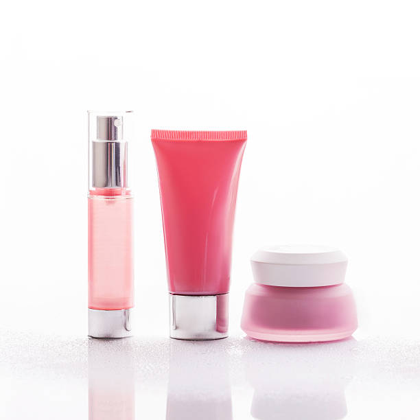 empty tubes of cream on a white background with tulips