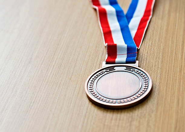 istock Single bronze medal on wood desk 622450648
