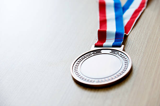 istock Single bronze medal on wood desk 622450716