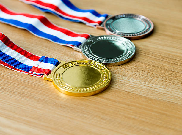 istock Gold, silver, and bronze medal on wood desk 622450980