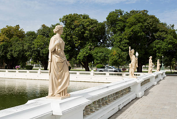 Ayutthaya, Thailand - November 4, 2016: View of the bridge with standing neoclassical statues on each balustrade at the Bang Pa-in Palace compound