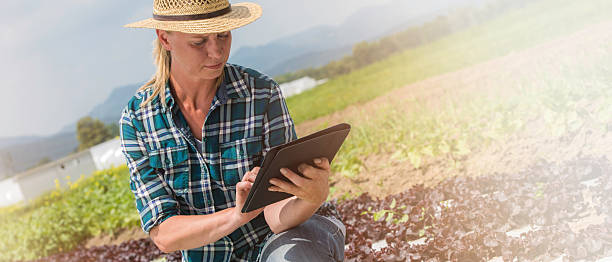 istock Kneeling female farmer with digital tablet 622454772