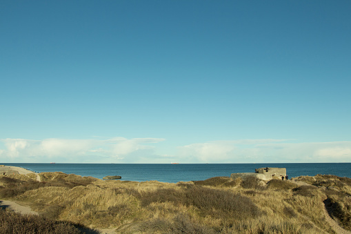 Bomb shelter on the coastline of Skagen headland promontory on the northern point of Denmark during sunny summer day