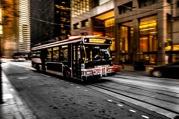 A TTC public transportation bus moves along Bloor Street in downtown Toronto Ontario Canada on a sunny day