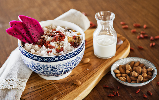 Muesli served with dragon fruit, almonds, goji berries and coconut flakes