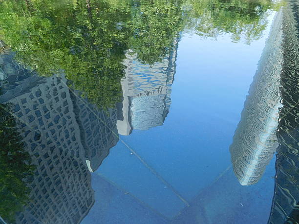 istock The office buildings reflected on the surface of water 622458038