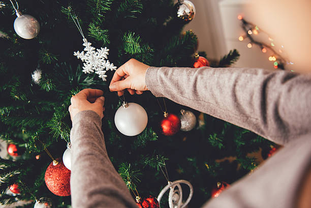 istock Woman decorating a christmas tree 622459438