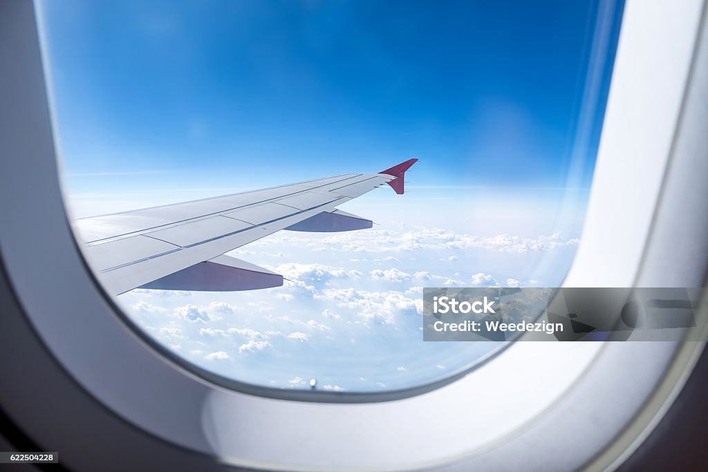 Close up Airplane window with airplane wing Close up Airplane window with airplane wing ,Traveling concept. Airplane Stock Photo