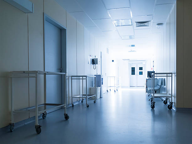 hospital corridor Corridor in hospital with carts illuminated by sunlight muster station stock pictures, royalty-free photos & images