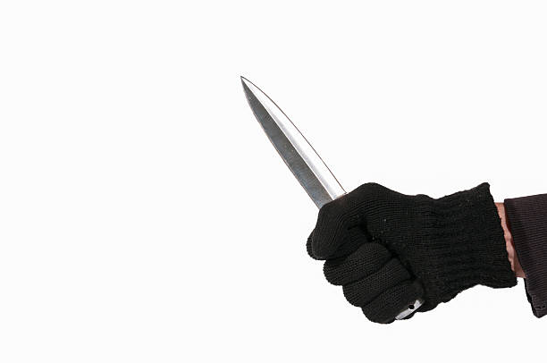 istock Hand with black glove holding a dagger 622515010