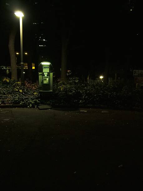 Shooting a public phone at a park in the night