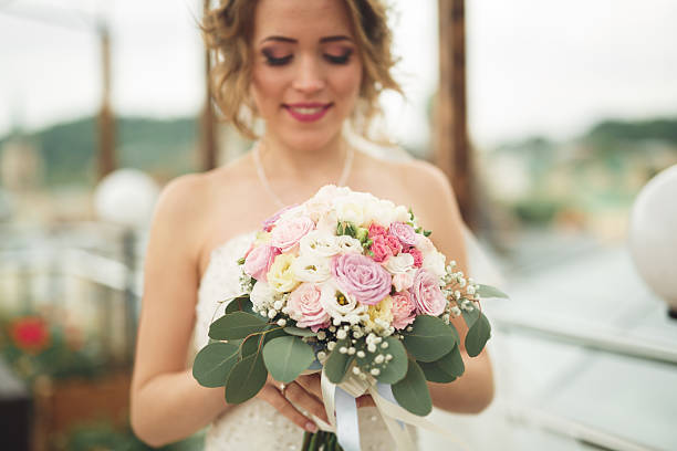 istock Bride holding big wedding bouquet on ceremony with perfect landscape 622521292