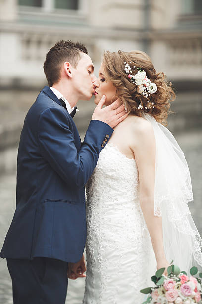 istock Just married wedding couple posing and bride holding in hands 622522678