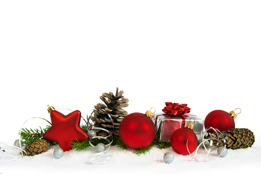 Christmas lower decoration with balls, cones and gift on white background.