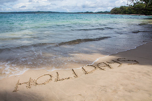 istock Holidays written in the sand on the beach 622529822