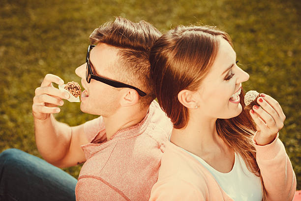 istock Lovely couple eating cupcakes. 622531270