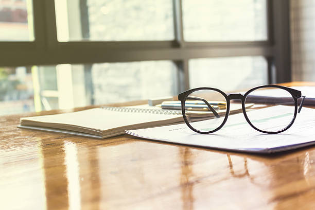istock Close up of eye glasses on work desk with chart 622531474