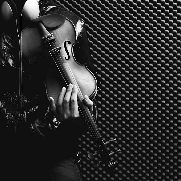 istock male musician playing violin in recording studio 622531518
