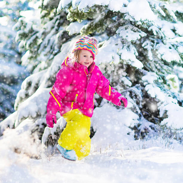 istock Child having fun in snowy winter park 622531608