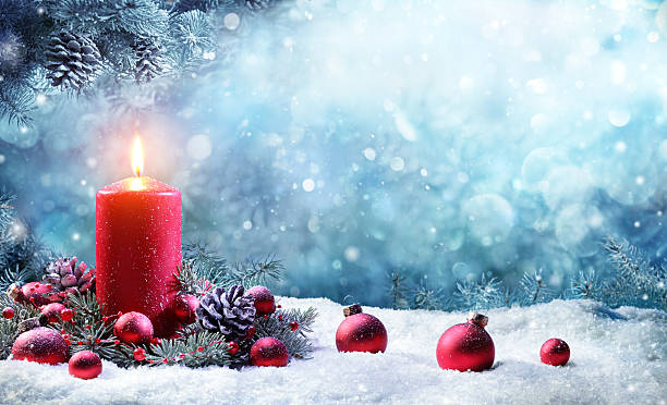 istock Advent Candle With Fir Branches Burning In Snowy Scene 622533434