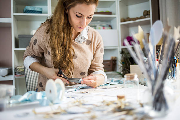 Design professional Artisan woman cutting paper in her atelier, small business owner art and craft photos stock pictures, royalty-free photos & images