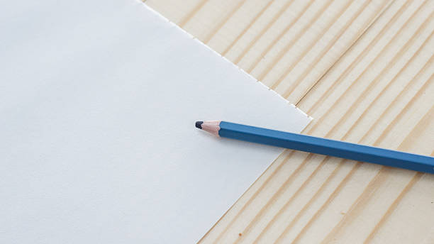 istock paper and pencil on a wooden table. 622534062