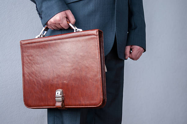 istock Brown briefcase in hand, a businessman  the office 622537724