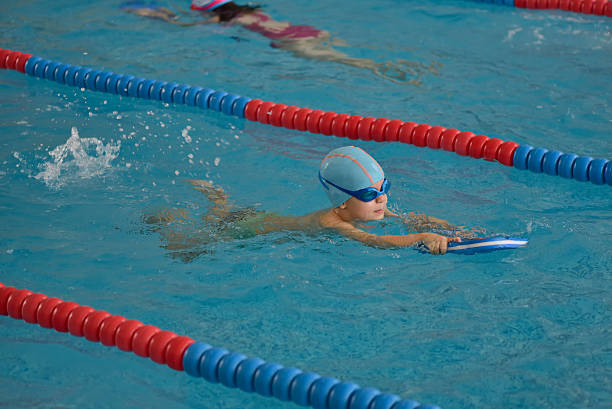 istock Little boy learning to swim in an indoor pool 622538864