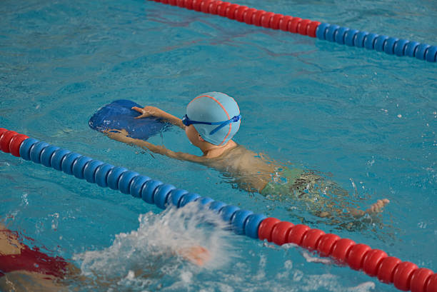 istock Little boy learning to swim in an indoor pool 622538948