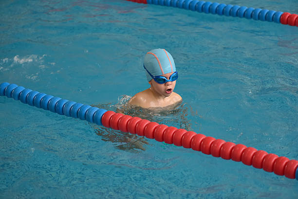 istock Happy little boy swimming in an indoor pool 622539232