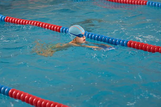 istock Happy little boy learning to swim in an indoor pool 622539332