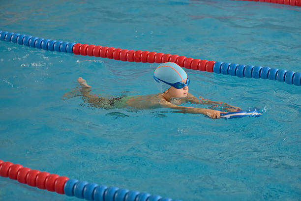 istock Happy little boy learning to swim in an indoor pool 622539430