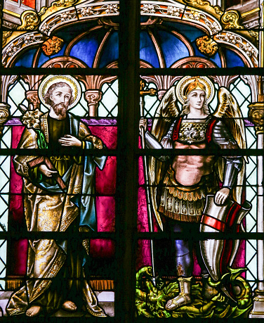 Mechelen, Belgium - January 31, 2015: Stained Glass window depicting Saint Joseph and the Archangel Saint Michael, in the Cathedral of Saint Rumbold in Mechelen, Belgium.