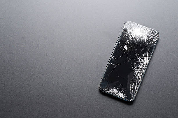 Smartphone with broken screen on dark background Smartphone with broken screen on dark background. great ape photos stock pictures, royalty-free photos & images