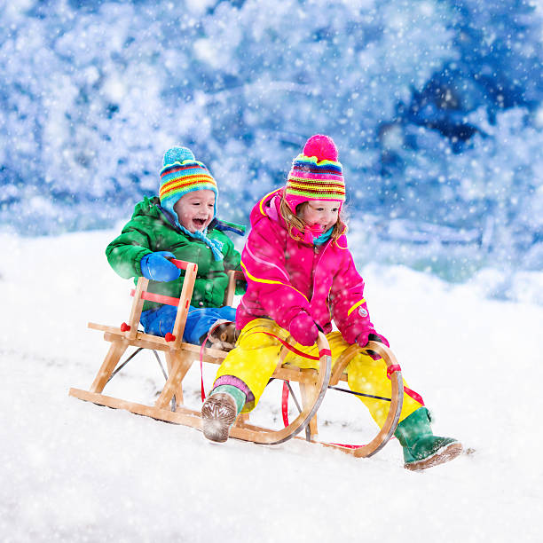 istock Kids having fun on sleigh ride during Christmas vacation 622540732
