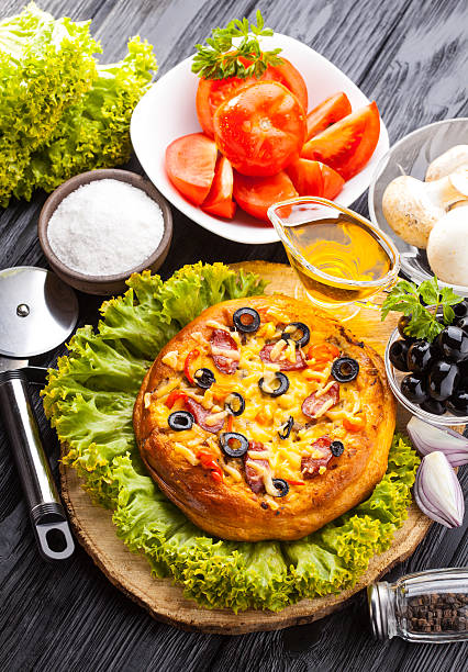 istock Delicious Homemade pizza served on wooden table 622541568