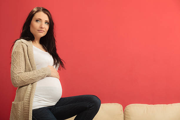 istock pregnant woman touching her belly 622542468