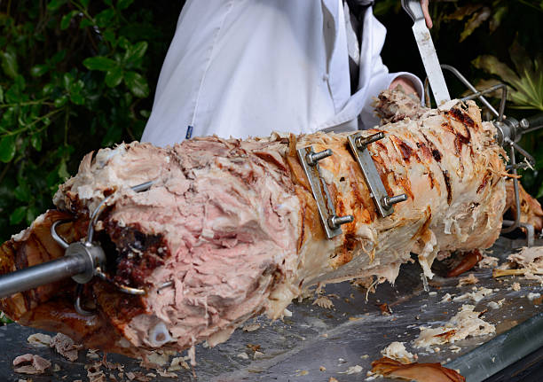 Pig Roast. Carving a pig roast. celebrity roast stock pictures, royalty-free photos & images