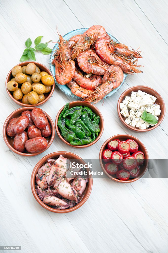 Choice of tasty Spanish tapas on a wooeden table Choice of Spanish tapas.Choice of Spanish tapas. Tapas Stock Photo