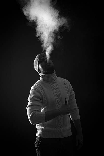 istock Men with beard vaping on black background in hat 622546804