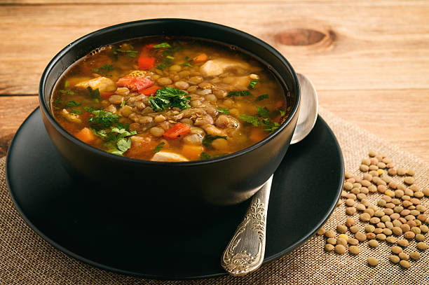 Hot soup with green lentil, chicken, vegetables and spices. stock photo