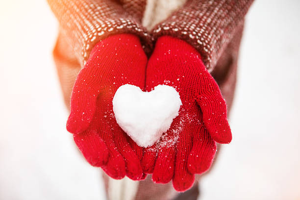 snowy heart woman holds in her hands a snowy heart 21 24 months stock pictures, royalty-free photos & images