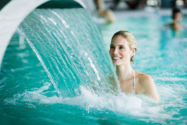 Woman enjoying hydrotherapy in spa pool Woman enjoying hydrotherapy and water stream in spa pool hydrotherapy stock pictures, royalty-free photos & images