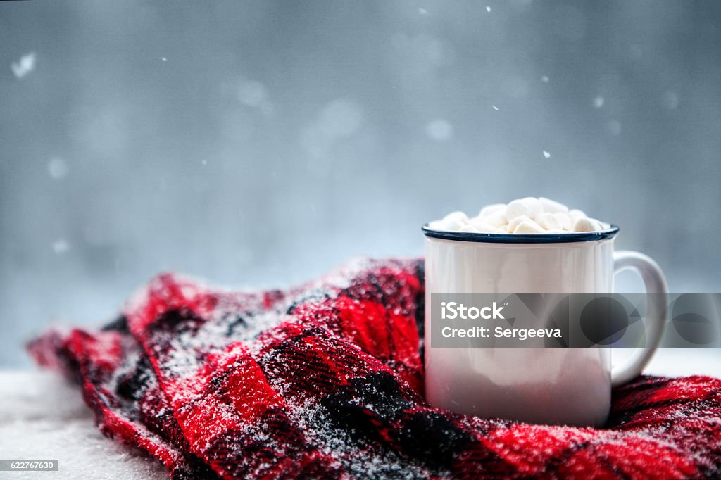 hot chocolate in winter hot chocolate and a blanket in the snow Winter Stock Photo