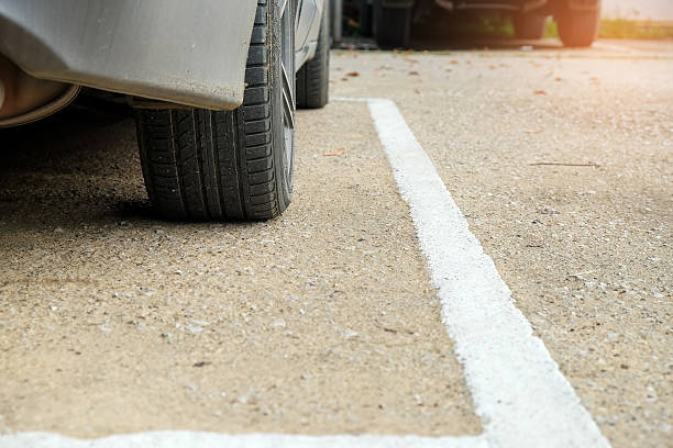 istock Car wheels in park take the wheel and white lines. 622776438