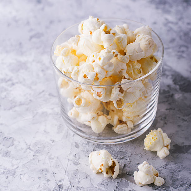 istock Popcorn in glass bowl on white background. 622777130