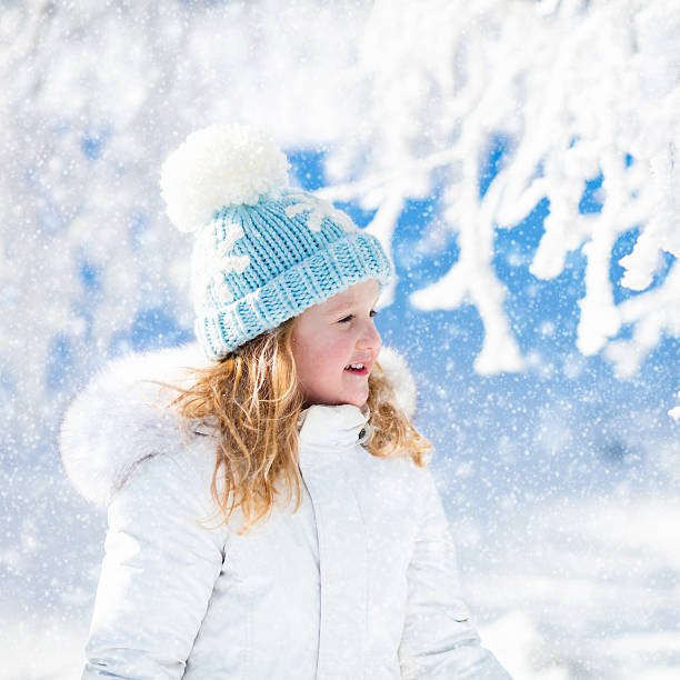 istock Child having fun in snowy winter forest 622779348