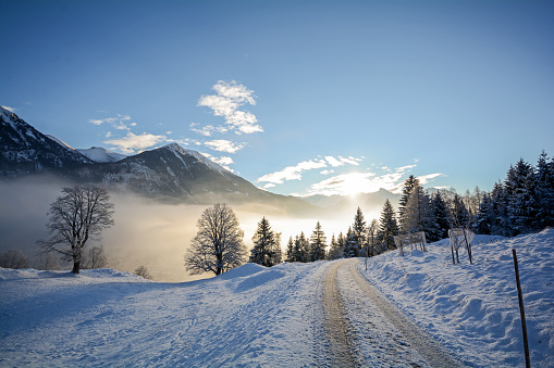 Winter landscape with icy road near Salzburg in Austria, Europe
